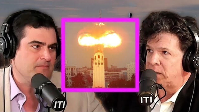 two men in front of microphones with a large explosion in the background